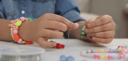 Little Girl Making Beaded Jewelry 600Nw 2110175006